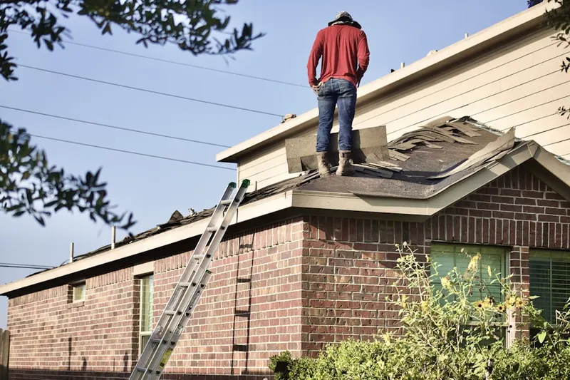 Professional roofer working on a residential roof in Benbrook